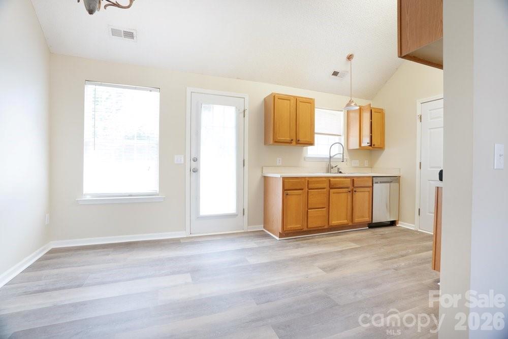 122 Addison Place Troutman, NC 28166 - Photo 8 of 40 a view of a kitchen with wooden floor and electronic appliances