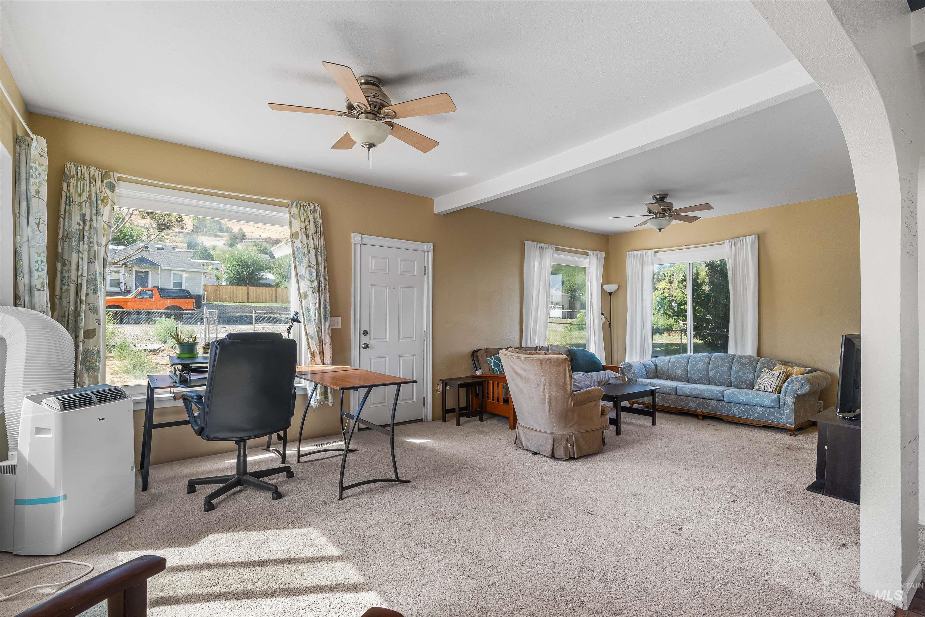 815 2nd Street Asotin, WA 99402 - Photo 6 of 50 Home office with beamed ceiling, arched walkways, carpet floors, and ceiling fan