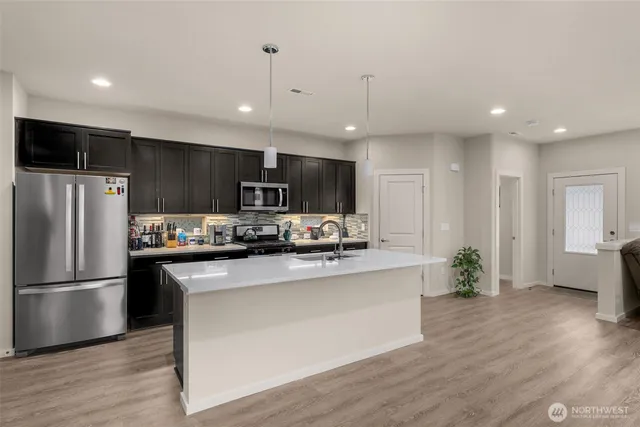 a view of kitchen with sink microwave and stove