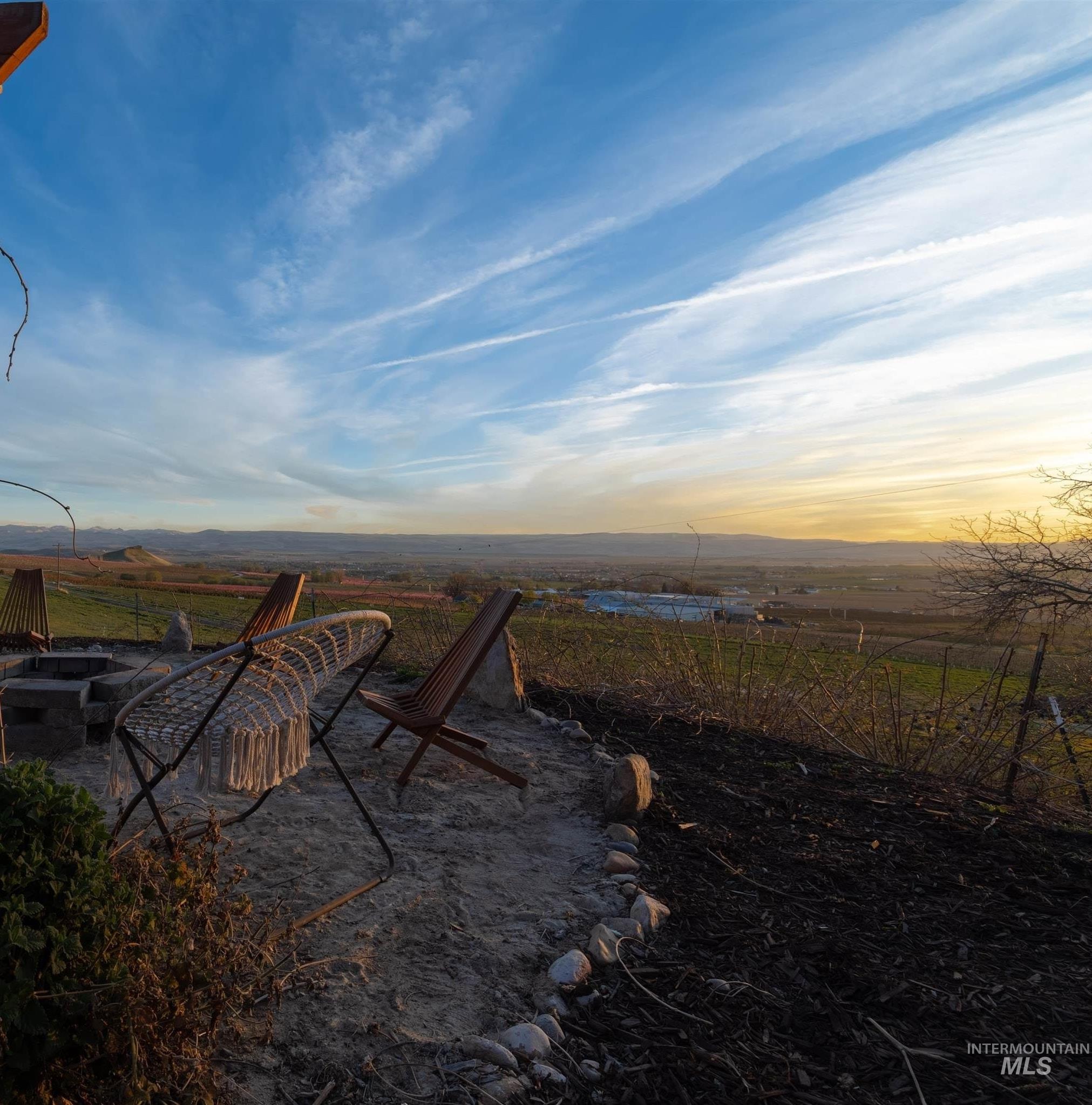 14526 Perfection Lane Caldwell, ID 83607 - Photo 4 of 47 Outdoor living area featuring a wood pergola, integrated fire pit, and a wide natural landscape