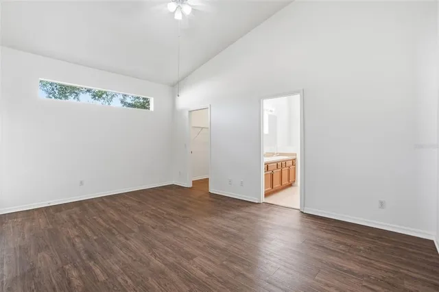 a view of an empty room with wooden floor