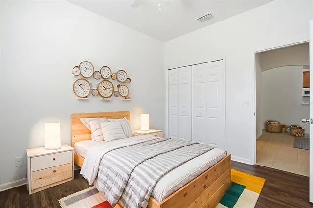 a bedroom with a bed and wooden floor