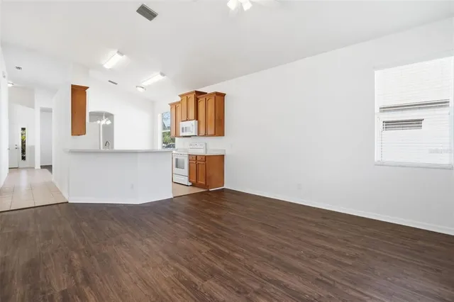a view of a kitchen with wooden floor and a sink