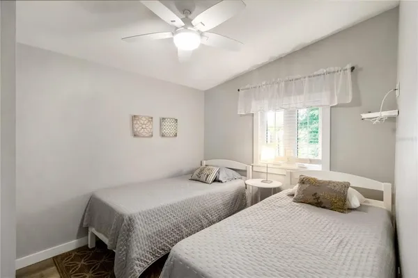 a bedroom with two beds and a chandelier