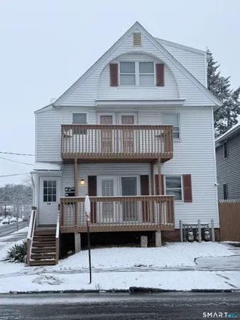 a view of a house with wooden deck