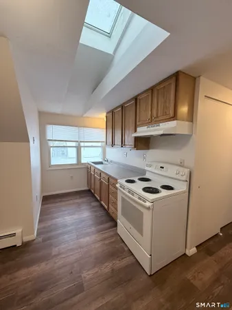 a kitchen with wooden floors and a stove