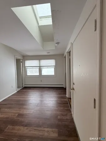 a view of wooden floor and windows in an empty room