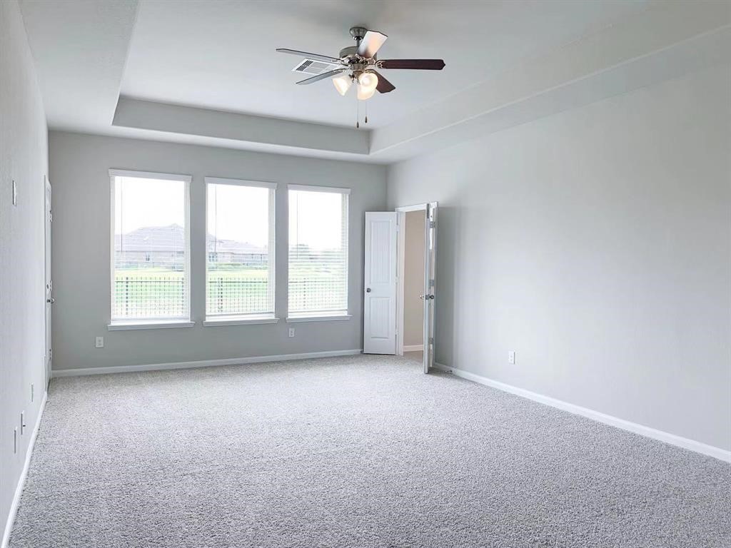 29026 Endeavor River Road Katy, TX 77494 - Photo 11 of 27 wooden floor in an empty room with a window