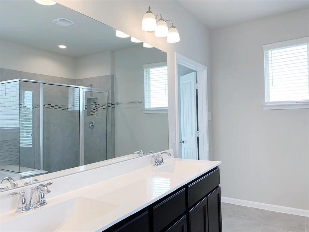 29026 Endeavor River Road Katy, TX 77494 - Photo 14 of 27 a bathroom with a sink a light fixture and a mirror