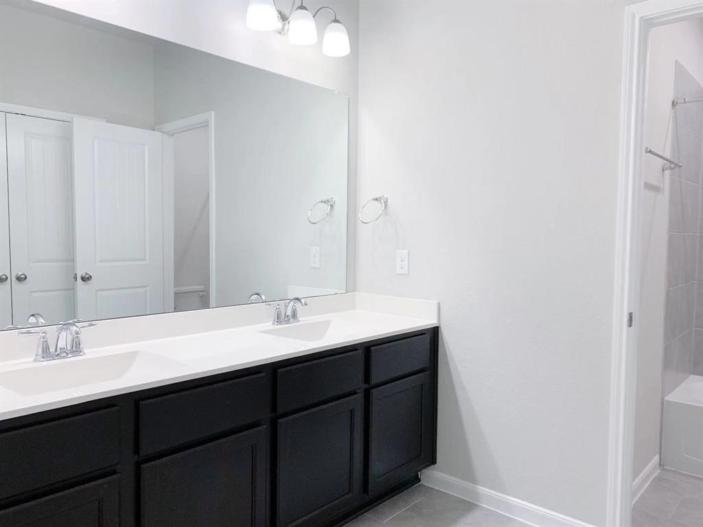 29026 Endeavor River Road Katy, TX 77494 - Photo 18 of 27 a bathroom with a double vanity sink and a mirror