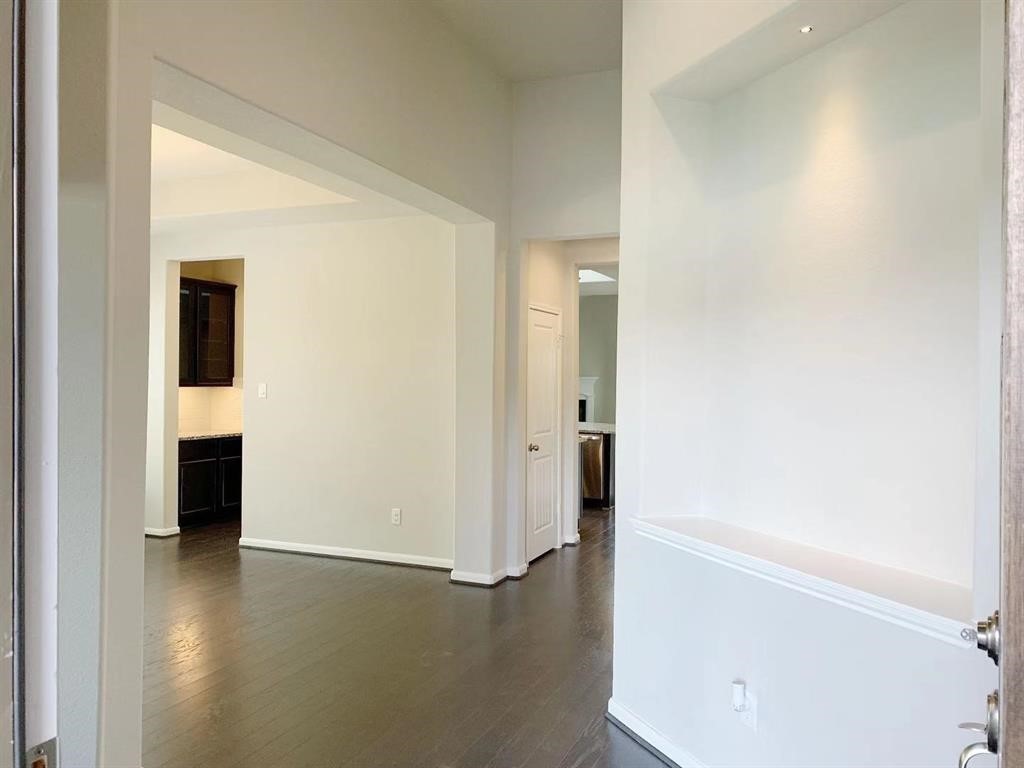 29026 Endeavor River Road Katy, TX 77494 - Photo 2 of 27 a view of a hallway with bathroom and wooden floor