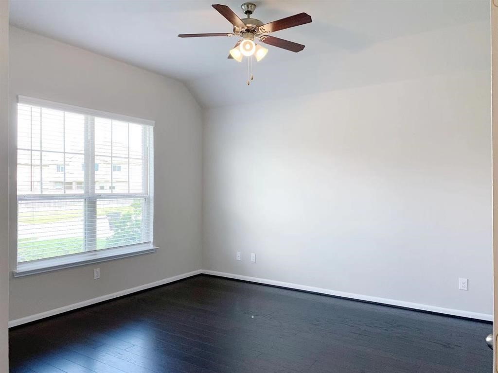 29026 Endeavor River Road Katy, TX 77494 - Photo 3 of 27 wooden floor in an empty room with a window