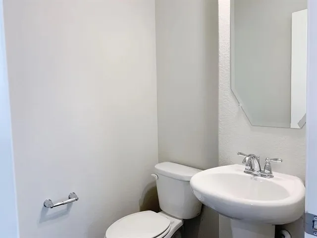 a kitchen with a sink dishwasher a stove and a refrigerator with wooden floor