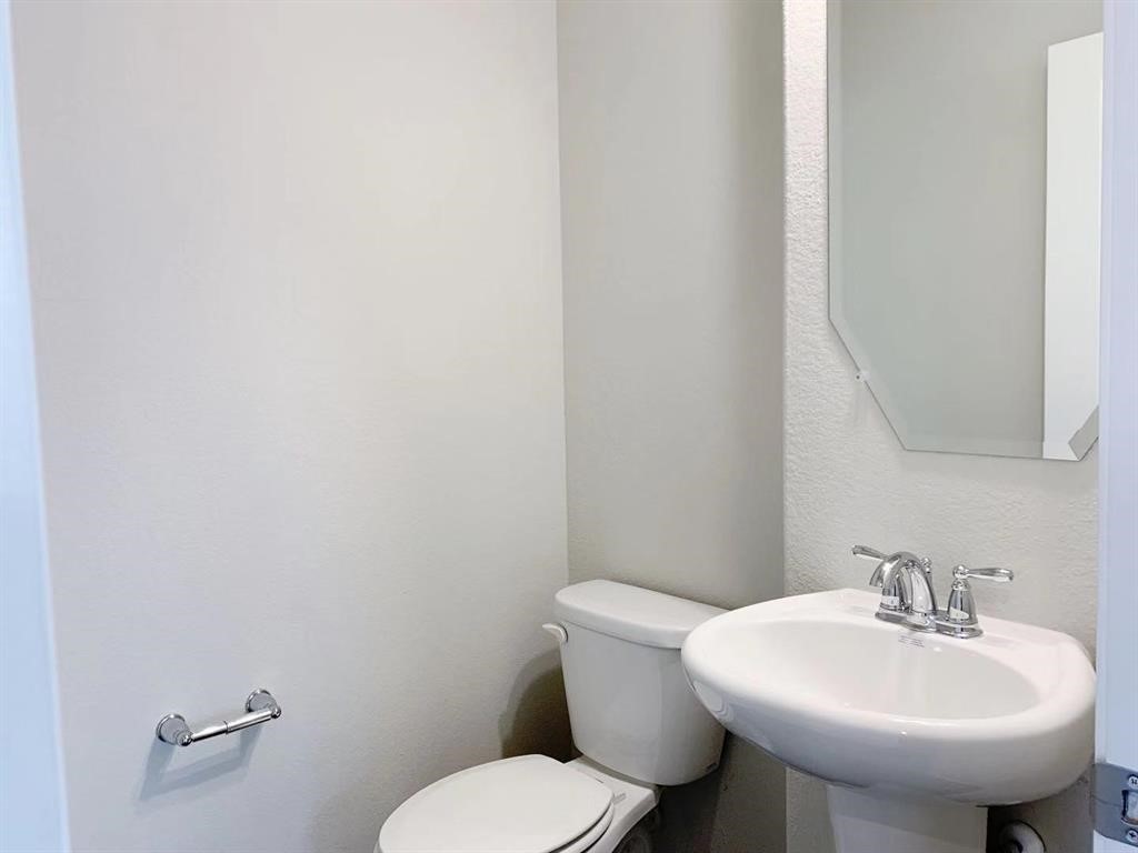 29026 Endeavor River Road Katy, TX 77494 - Photo 6 of 27 a bathroom with a toilet sink and mirror