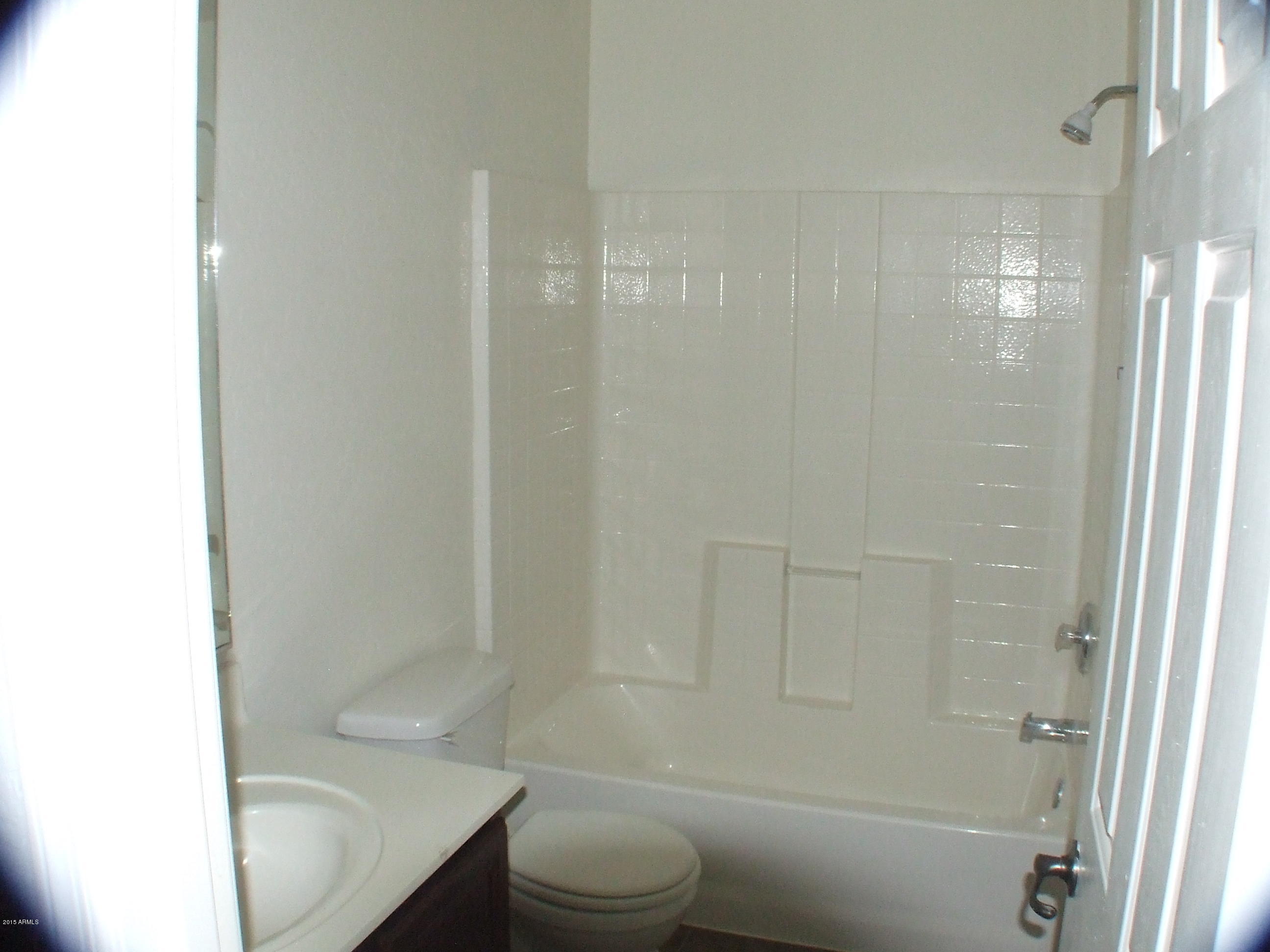 718 West Spruell Avenue Coolidge, AZ 85128 - Photo 15 of 15 a bathroom with a sink toilet and shower