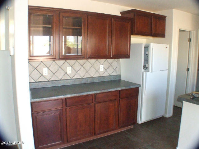 718 West Spruell Avenue Coolidge, AZ 85128 - Photo 2 of 15 a kitchen with stainless steel appliances a refrigerator and cabinets