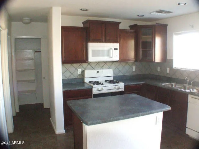 a kitchen with a sink stove and cabinets