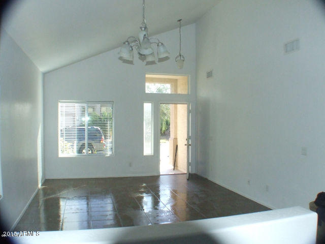 718 West Spruell Avenue Coolidge, AZ 85128 - Photo 5 of 15 a view of an empty room with wooden floor and a window
