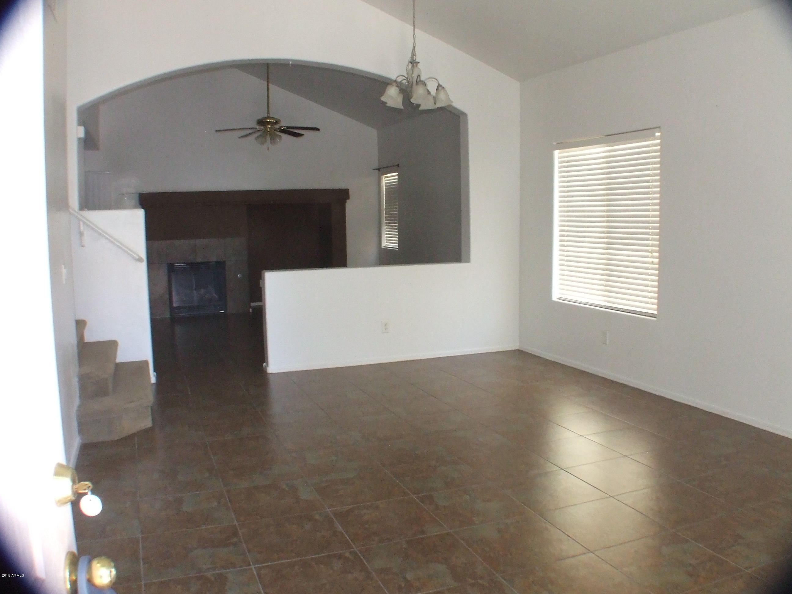 718 West Spruell Avenue Coolidge, AZ 85128 - Photo 6 of 15 an empty room with windows and fireplace