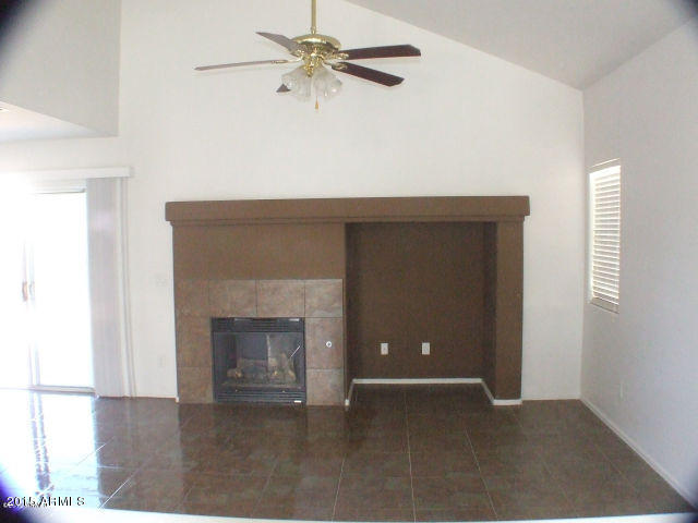 718 West Spruell Avenue Coolidge, AZ 85128 - Photo 7 of 15 an empty room with fan and a fireplace
