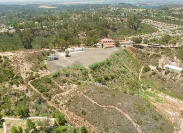 an aerial view of a tennis ground with large trees