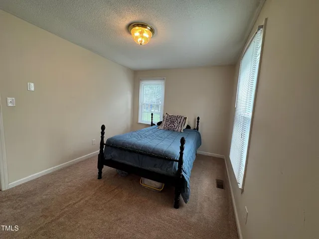 a bedroom with a bed and a table in it