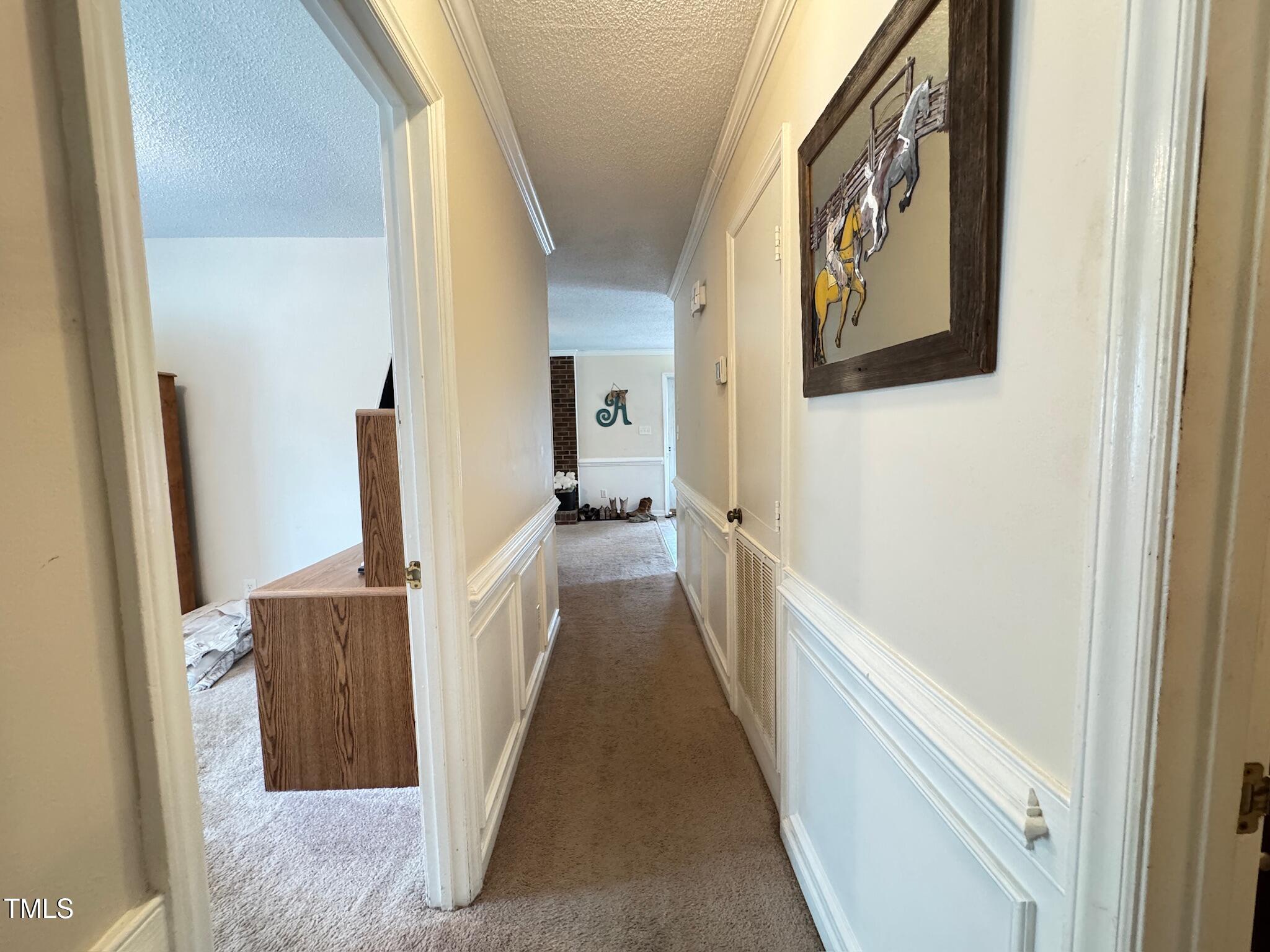 2229 Lizard Lick Road Zebulon, NC 27597 - Photo 20 of 57 a view of a hallway with wooden floor and staircase