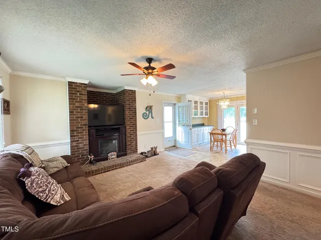 a living room with furniture and a chandelier