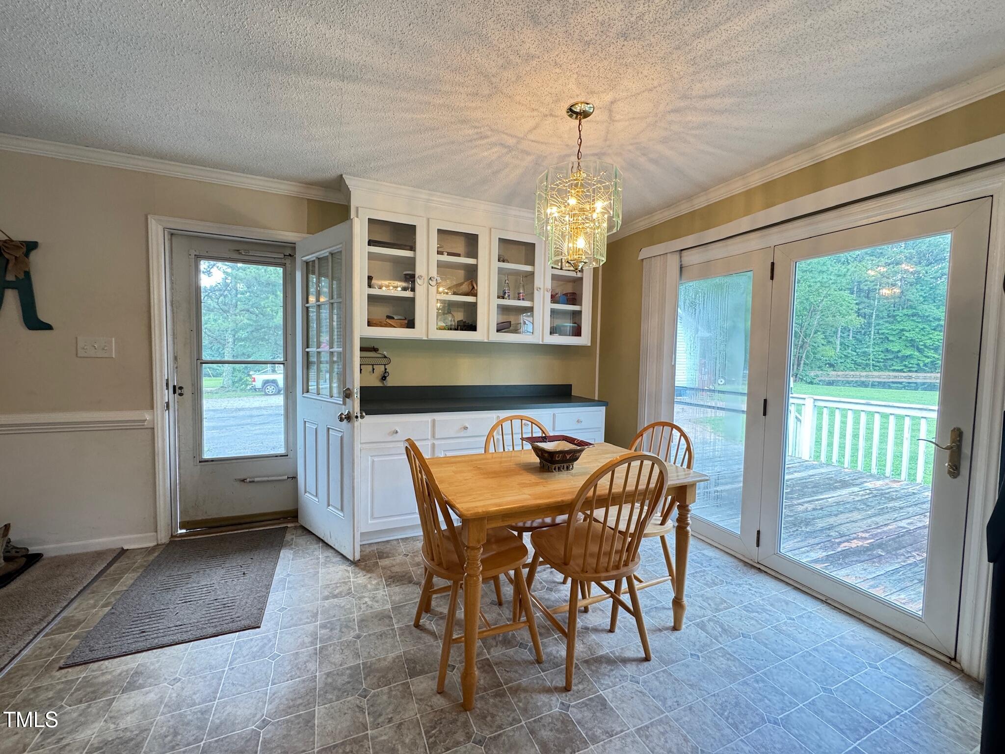 2229 Lizard Lick Road Zebulon, NC 27597 - Photo 29 of 57 a dining room with furniture a chandelier and wooden floor