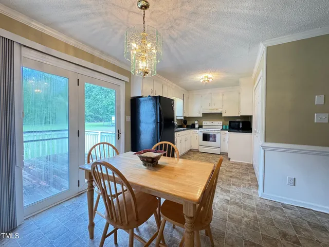 a kitchen with stainless steel appliances kitchen island granite countertop a refrigerator a stove a sink dishwasher and white countertops with wooden floor