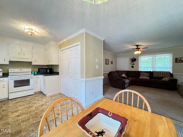 a dining room with furniture and window