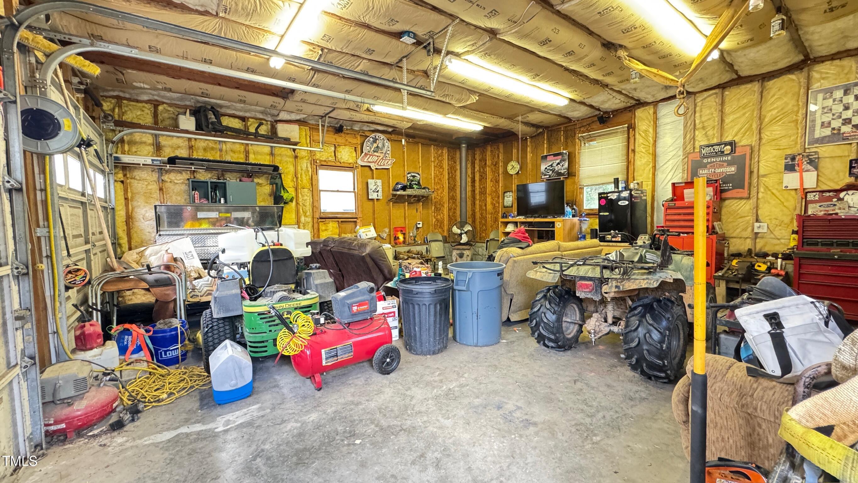 2229 Lizard Lick Road Zebulon, NC 27597 - Photo 39 of 57 a storage room with lots of clutter and chairs