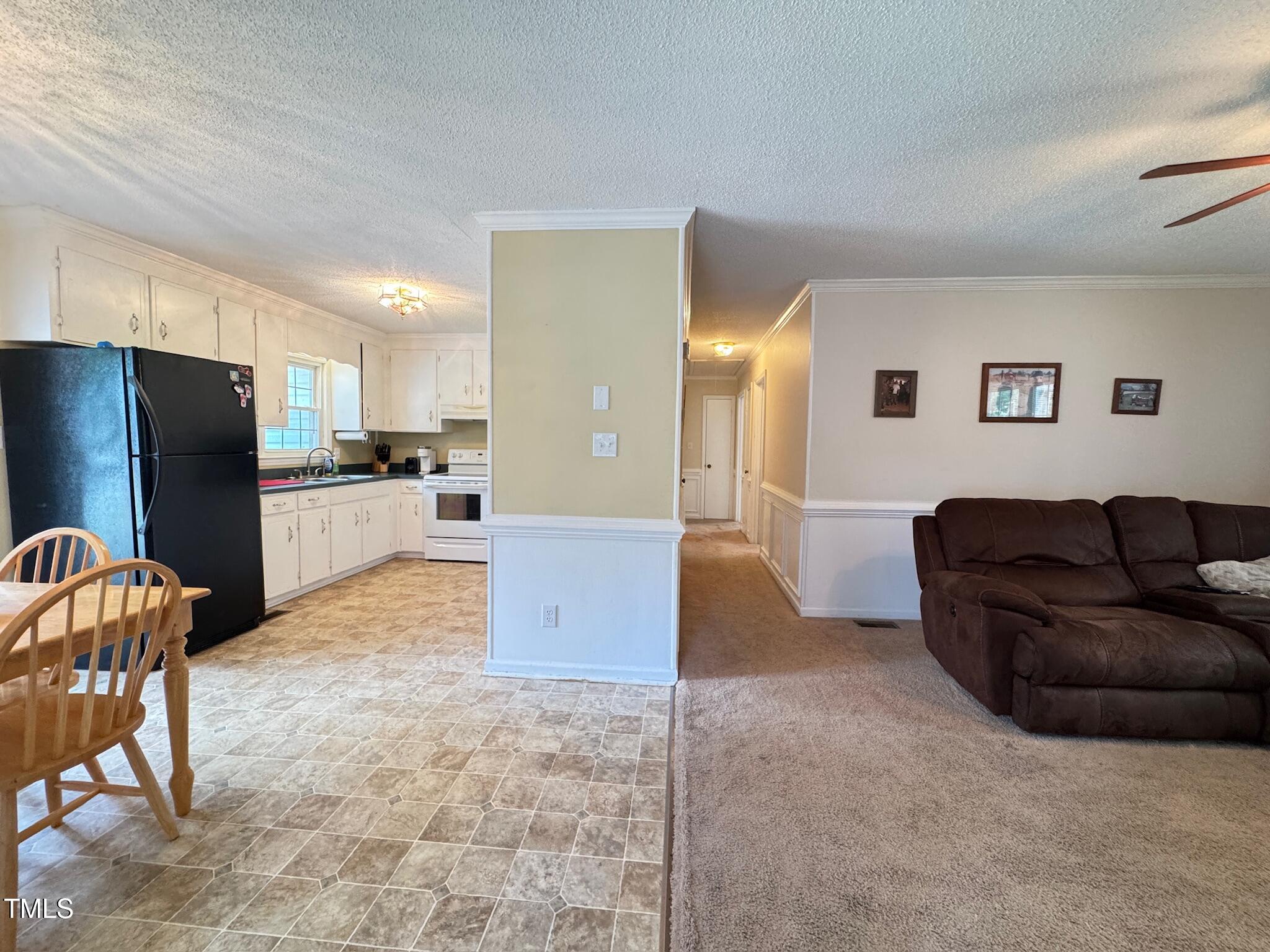 2229 Lizard Lick Road Zebulon, NC 27597 - Photo 41 of 57 a living room with furniture and a open kitchen view