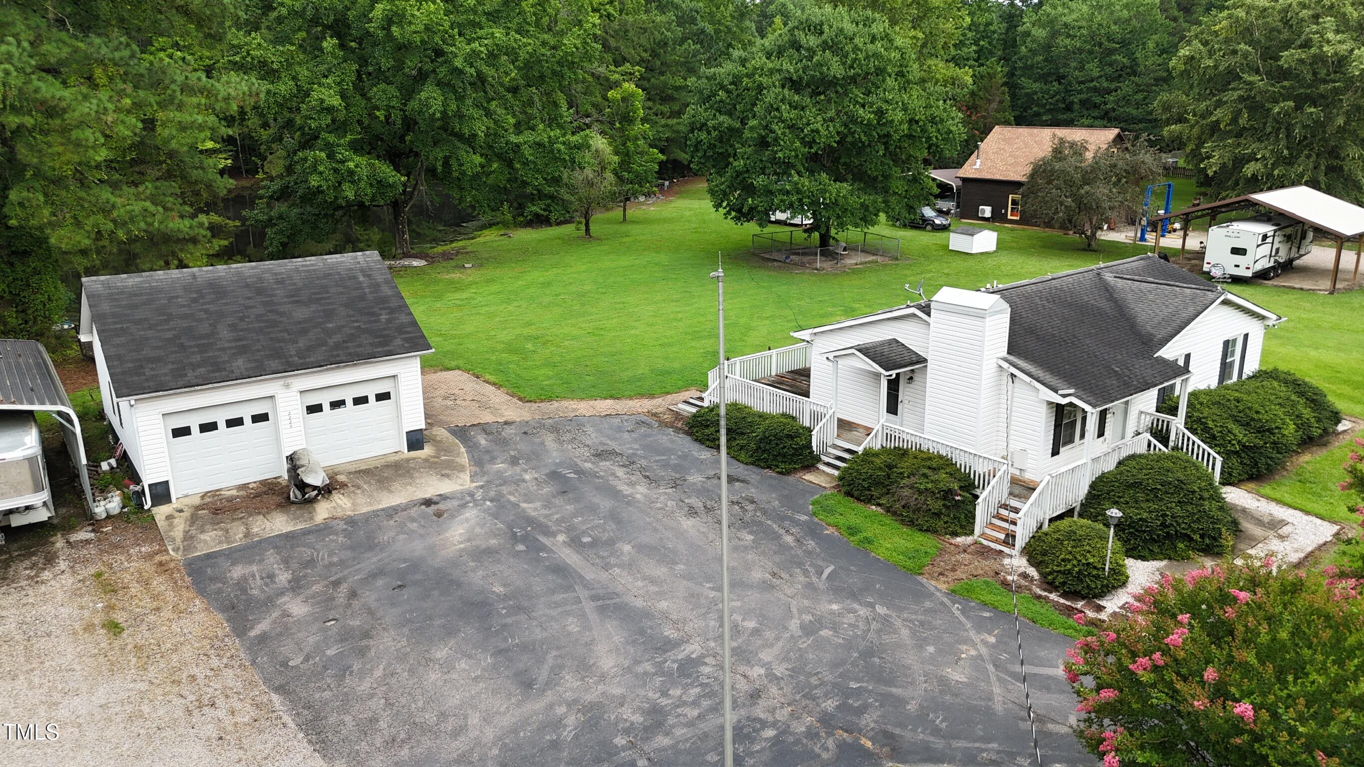 2229 Lizard Lick Road Zebulon, NC 27597 - Photo 52 of 57 an aerial view of a house with garden space and street view