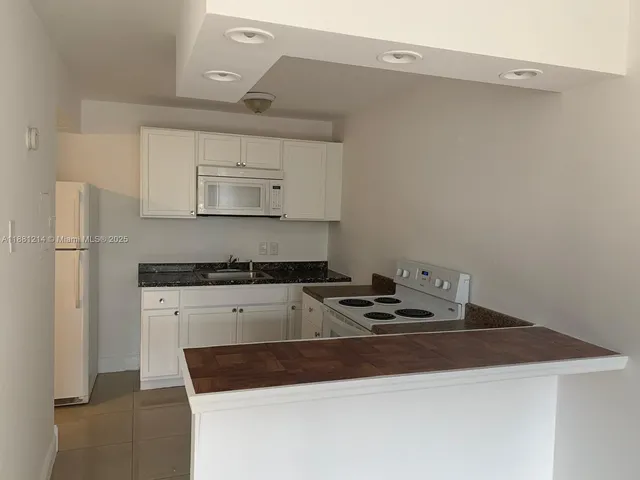 a kitchen with a stove and a refrigerator