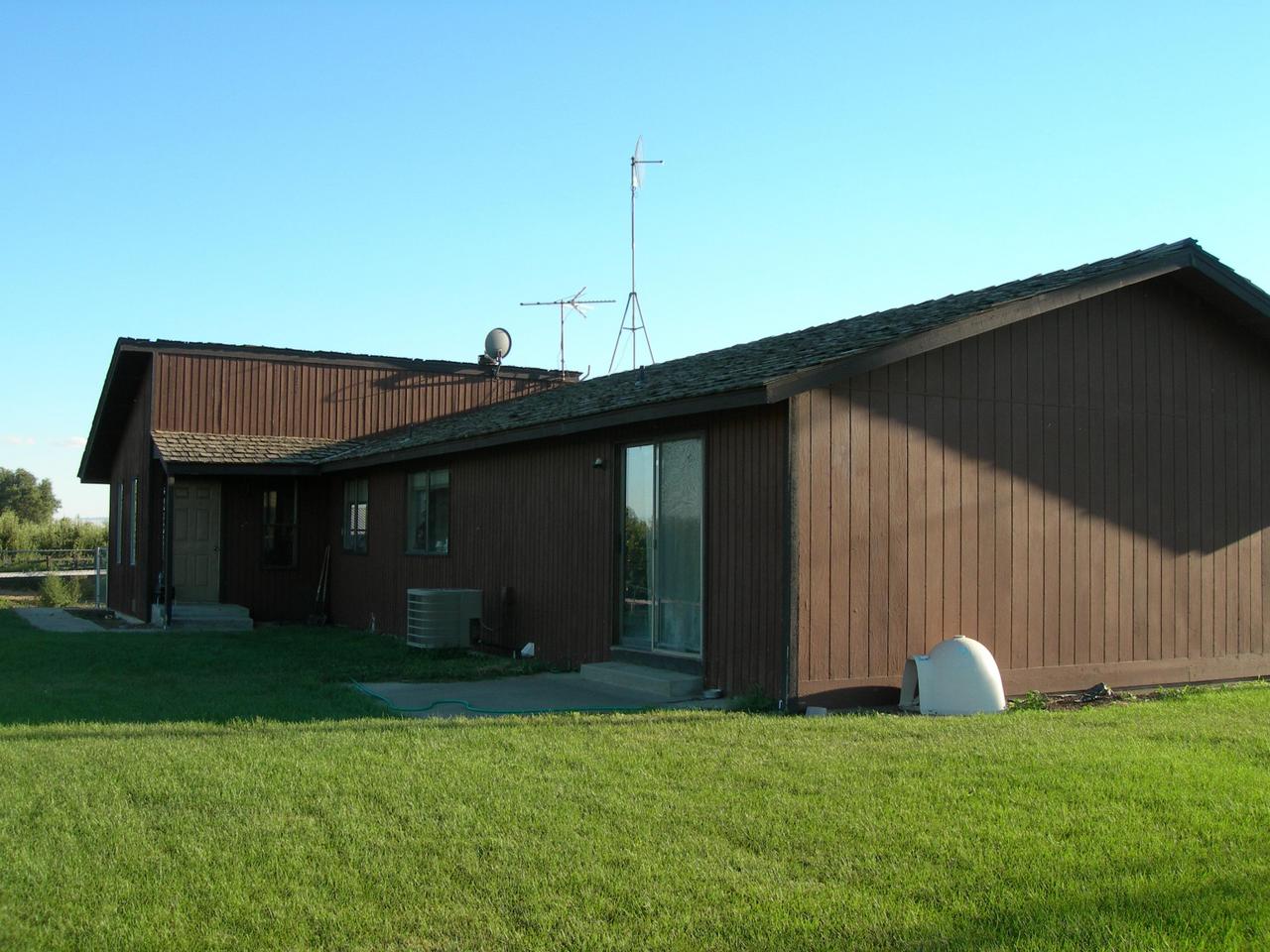 210 Liberty Road Granger, WA 98932 - Photo 1 of 8 a view of a house with a backyard