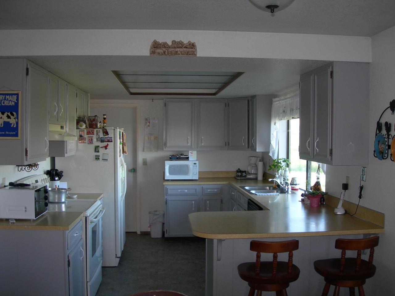 210 Liberty Road Granger, WA 98932 - Photo 2 of 8 a kitchen with a table chairs and a refrigerator