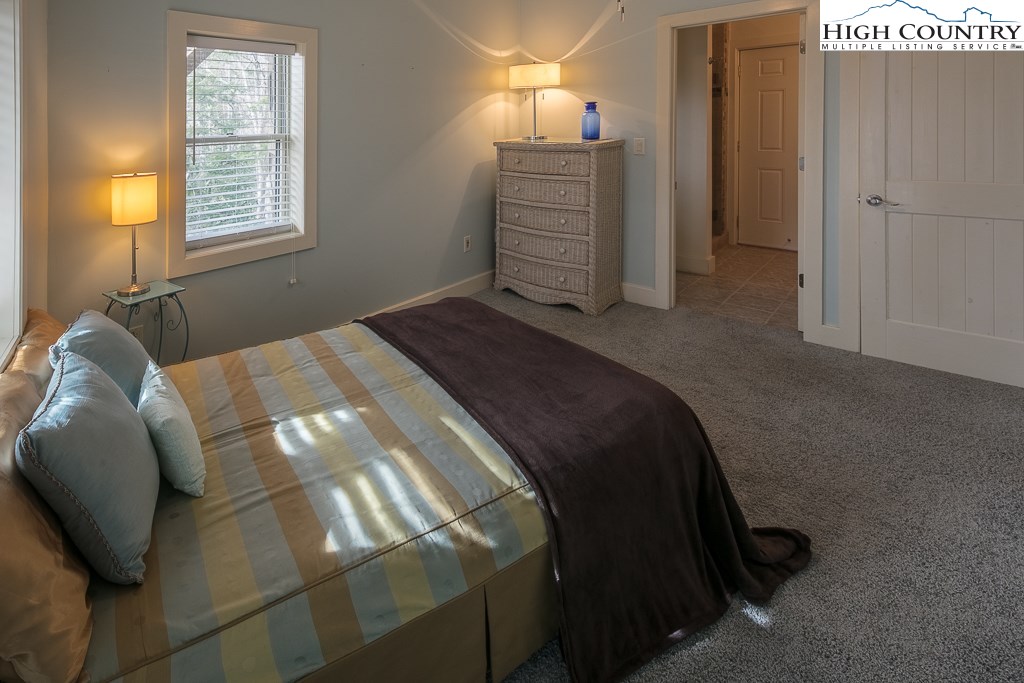 272 Locust Road Newland, NC 28657 - Photo 36 of 46 a bedroom with a bed and a mirror