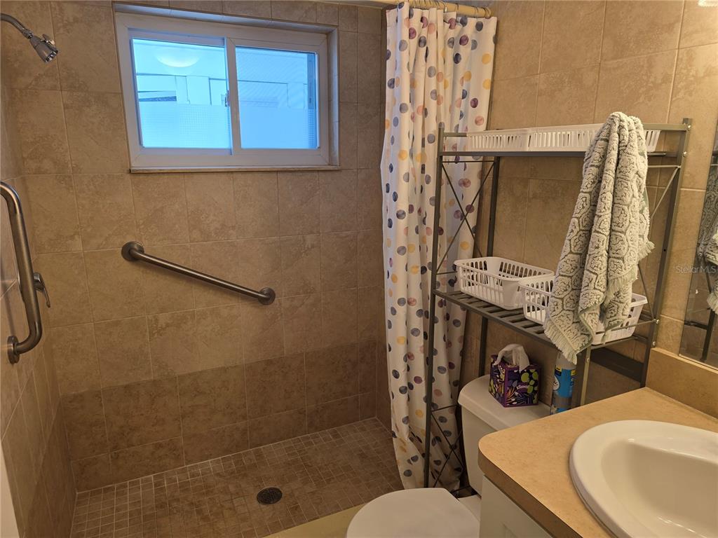 5850 Welcome Road, Unit J6 Bradenton, FL 34207 - Photo 15 of 30 a bathroom with a sink a toilet and shower