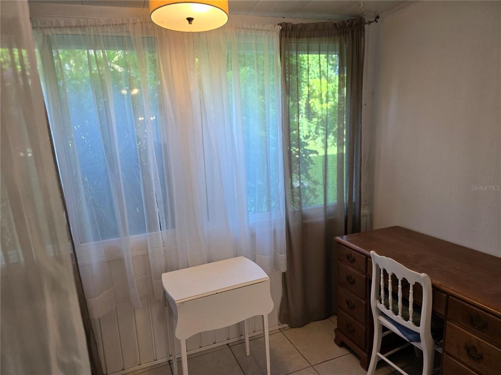 5850 Welcome Road, Unit J6 Bradenton, FL 34207 - Photo 19 of 30 a view of a hallway with windows and yard