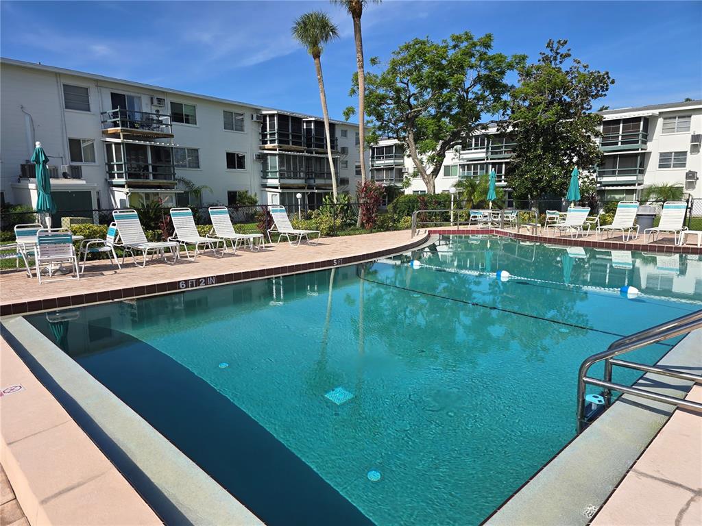5850 Welcome Road, Unit J6 Bradenton, FL 34207 - Photo 26 of 30 a view of a swimming pool with outdoor seating