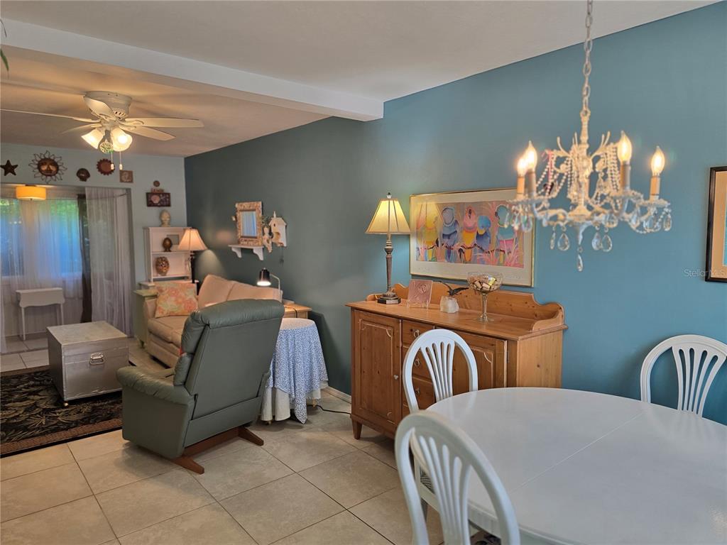 5850 Welcome Road, Unit J6 Bradenton, FL 34207 - Photo 6 of 30 a bedroom with a bed and ceiling fan