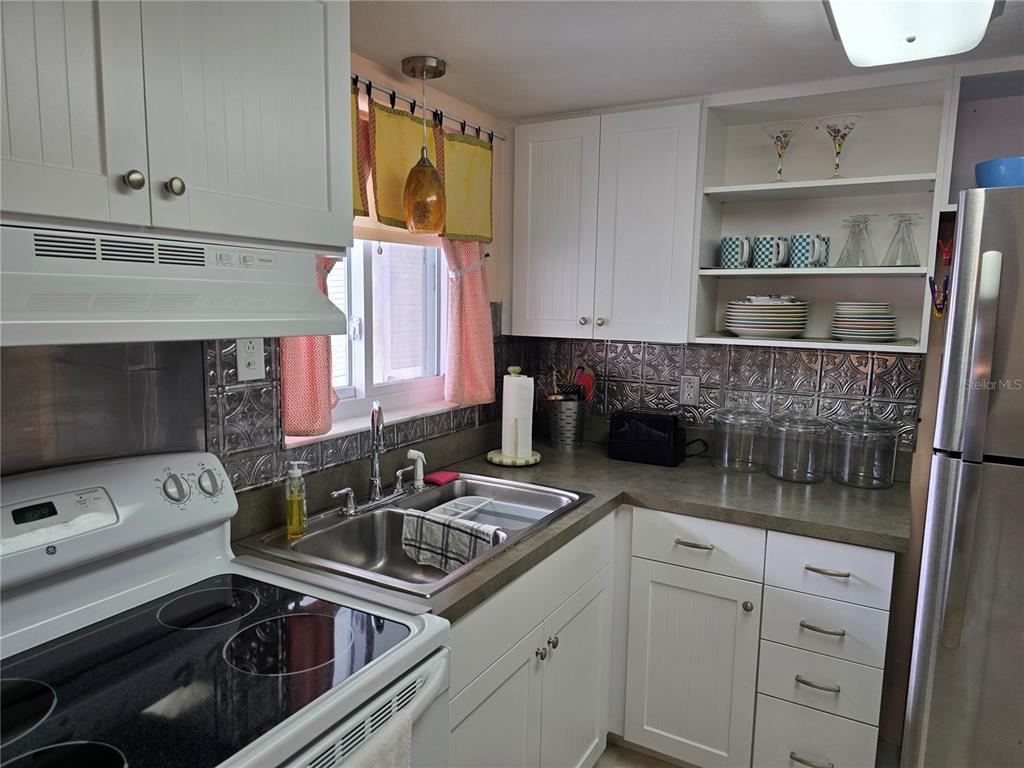 5850 Welcome Road, Unit J6 Bradenton, FL 34207 - Photo 10 of 30 a kitchen with a sink stove and cabinets