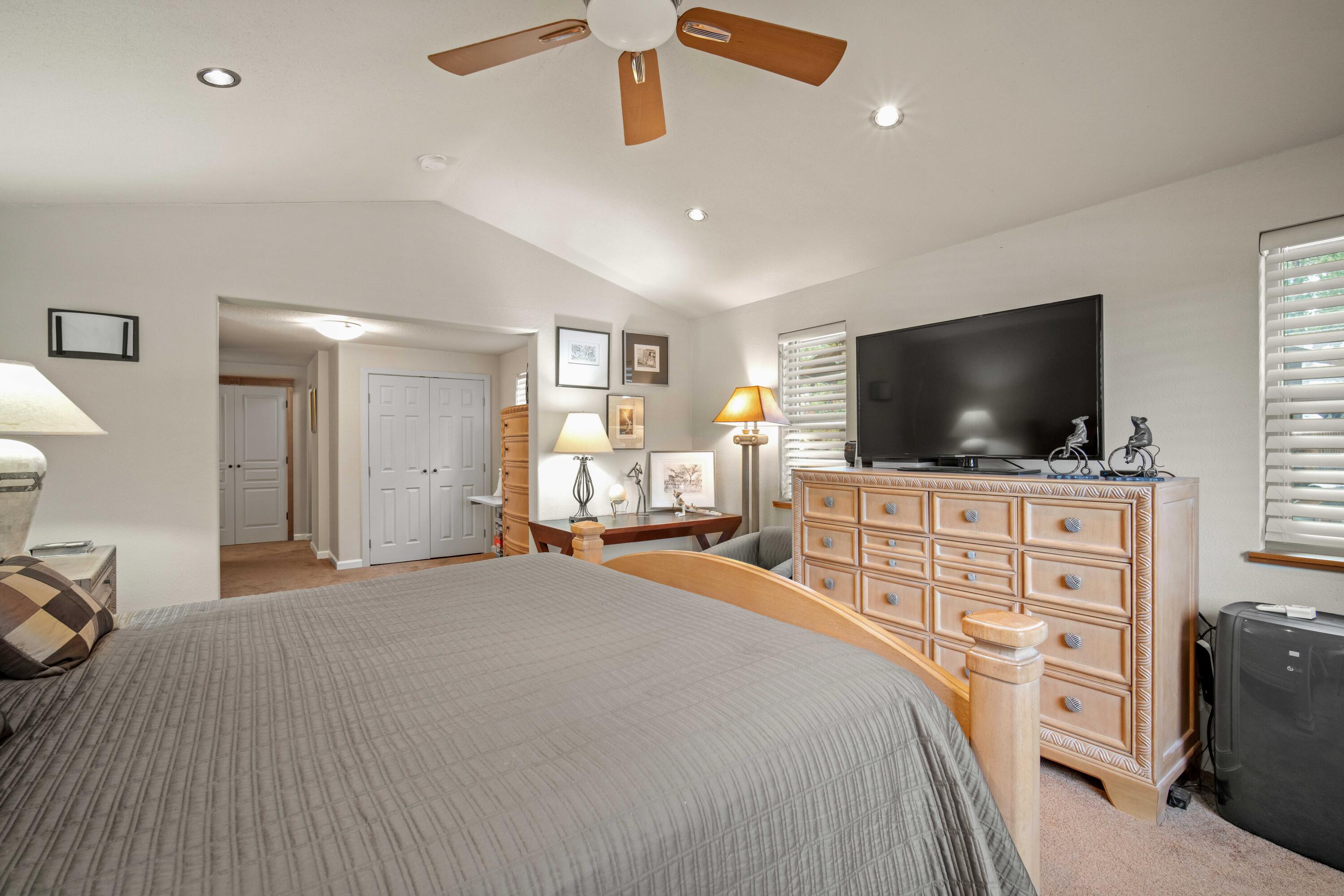 56019 Snow Goose Road Bend, OR 97707 - Photo 24 of 32 a bedroom with furniture and flat screen tv