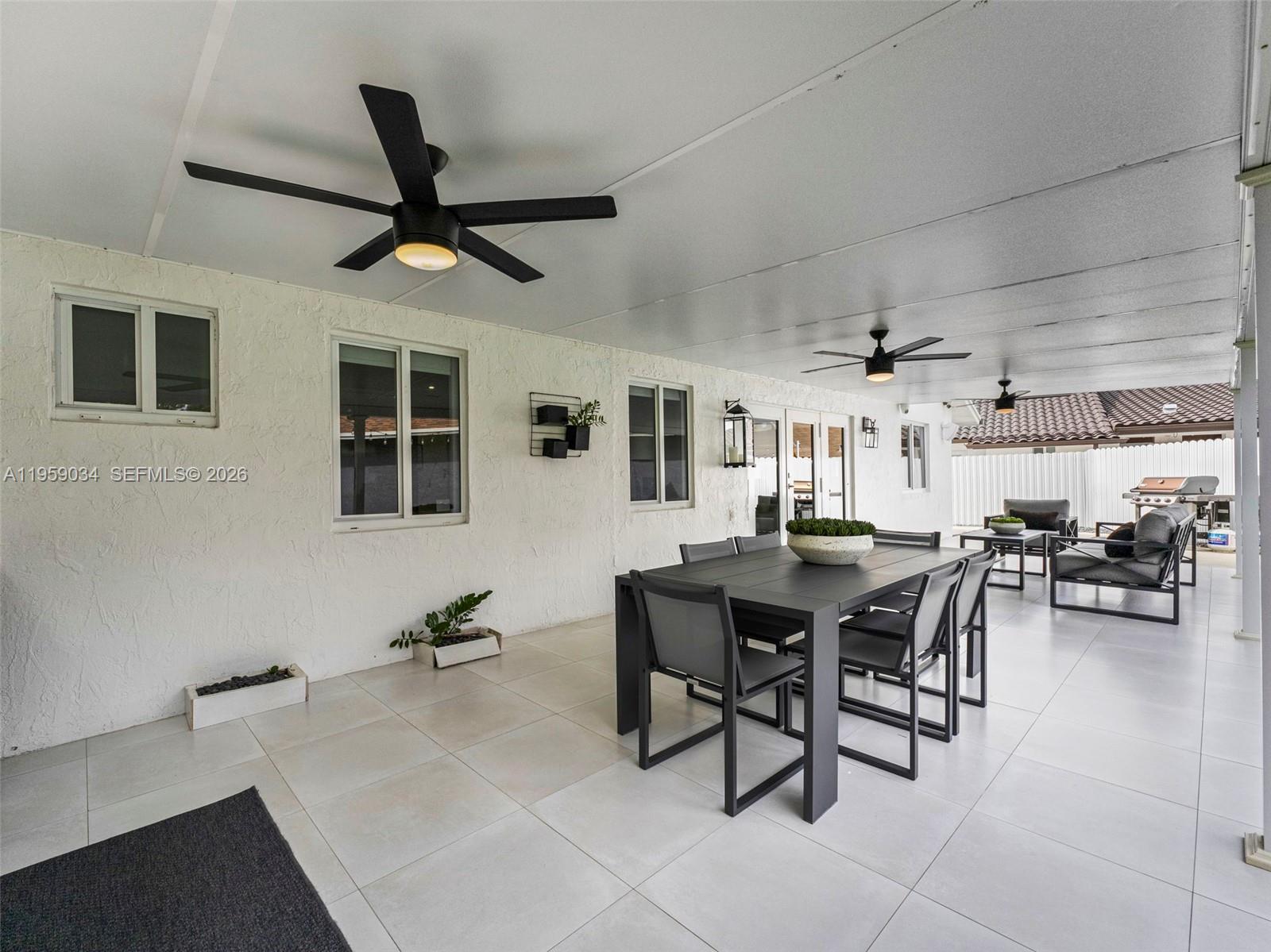 7753 Northwest 189th Street, Unit 1 Hialeah, FL 33015 - Photo 17 of 30 a dining room with furniture and window
