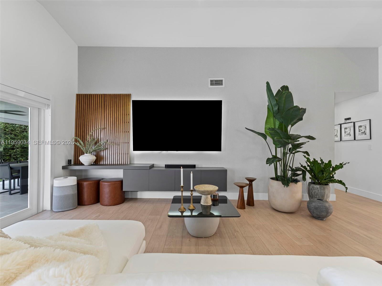 7753 Northwest 189th Street, Unit 1 Hialeah, FL 33015 - Photo 22 of 30 a living room with furniture and a potted plant
