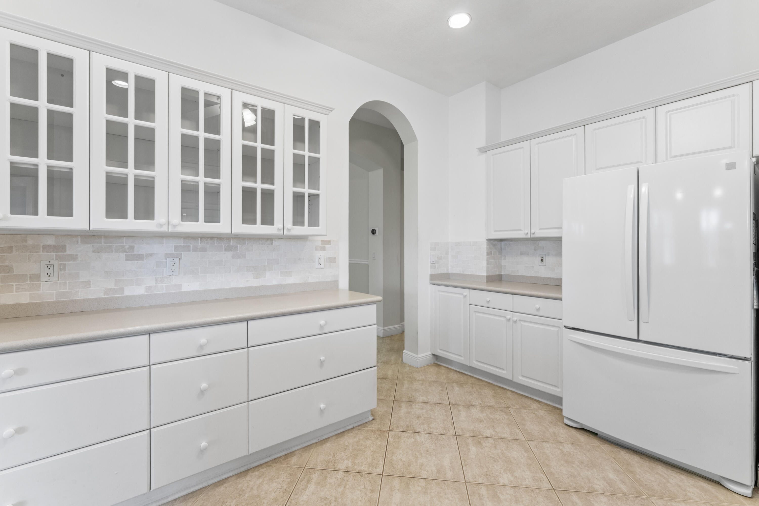 918 Southwest Blue Stem Way Stuart, FL 34997 - Photo 13 of 47 a kitchen with a refrigerator stove and cabinets