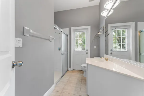 a spacious bathroom with a bathtub sink and mirror