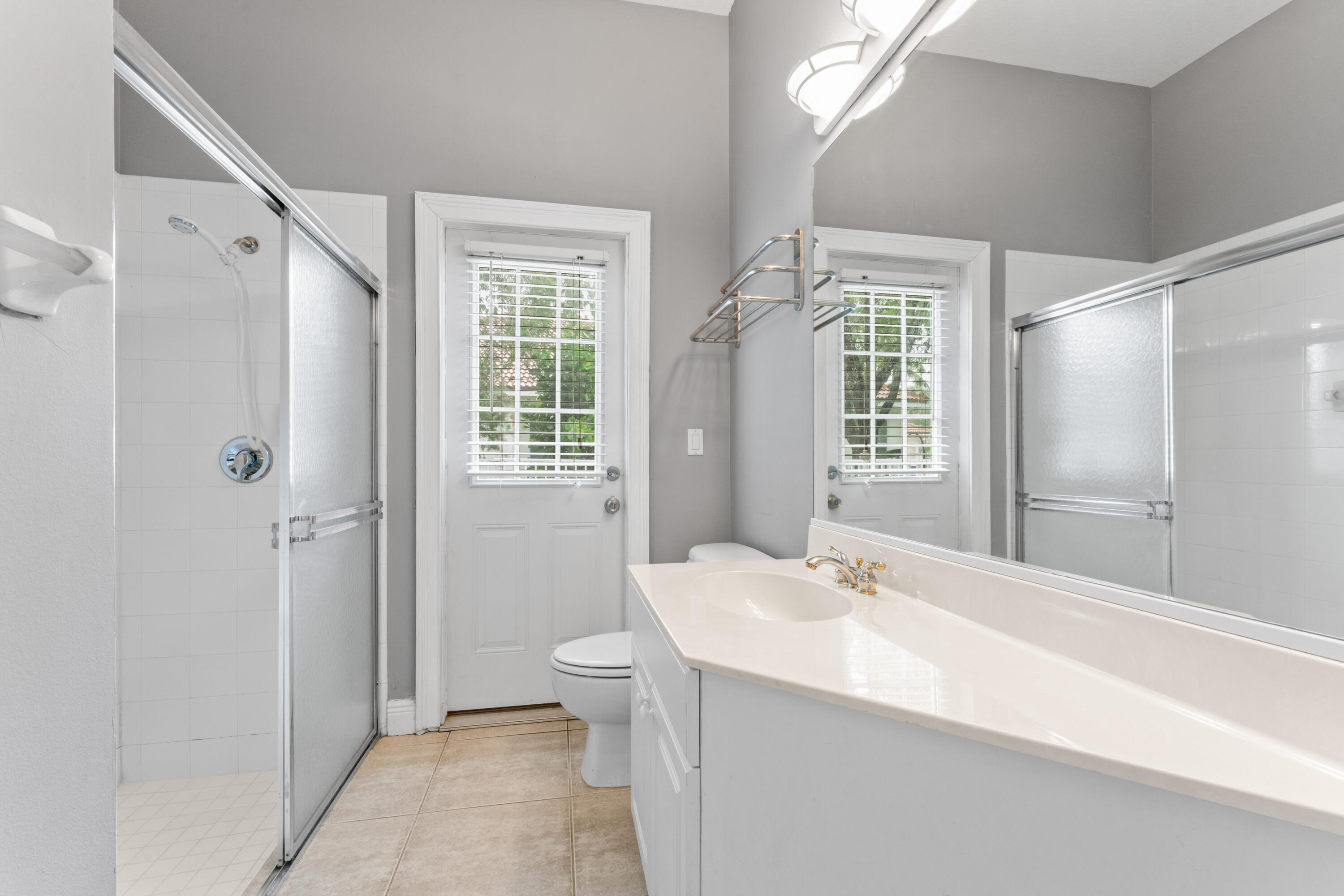 918 Southwest Blue Stem Way Stuart, FL 34997 - Photo 29 of 47 a bathroom with a sink a toilet and shower