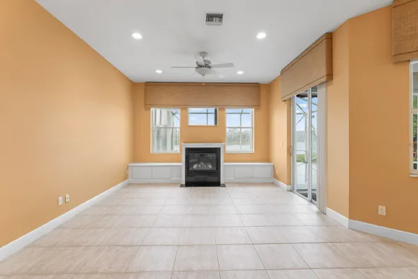 a view of an empty room with a fireplace and a window